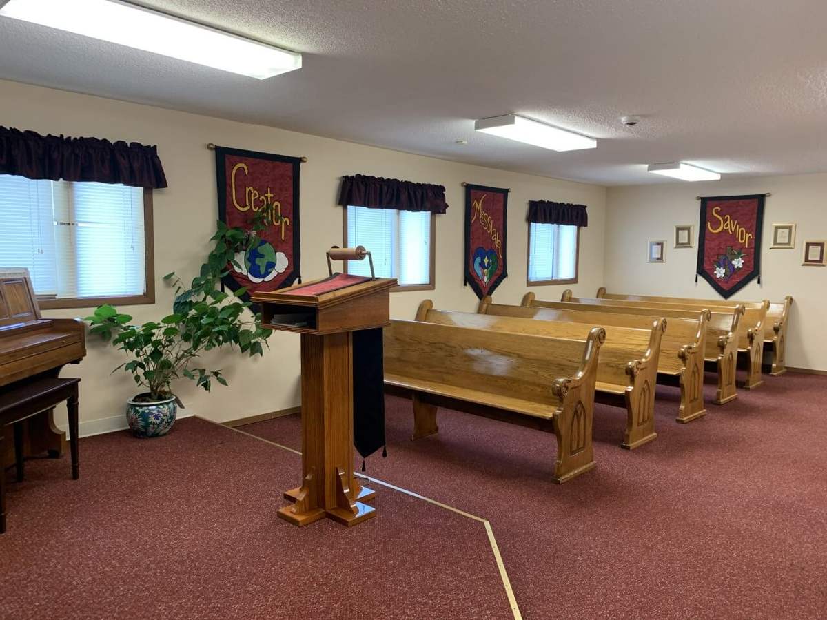 The chapel at the women's shelter, with wooden pews and red banners
