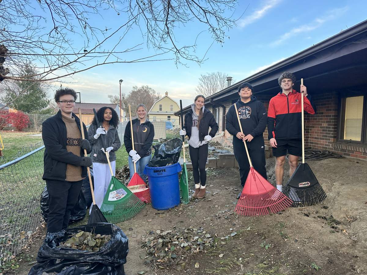 A National Honor Society volunteer group after a yard cleanup at the Mission